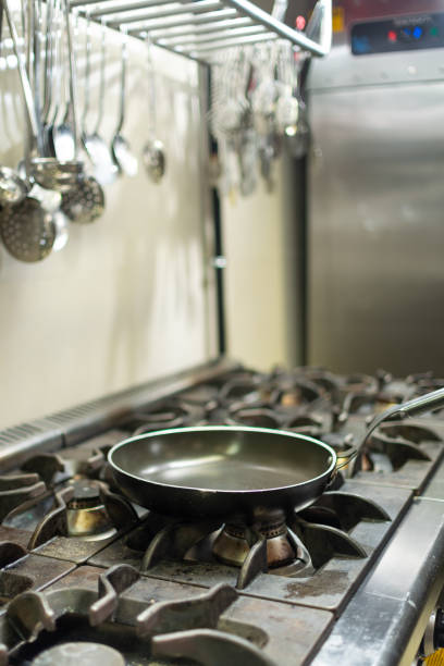 Empty pan on the stove stock photo