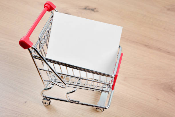 Empty paper in a shopping cart on table stock photo