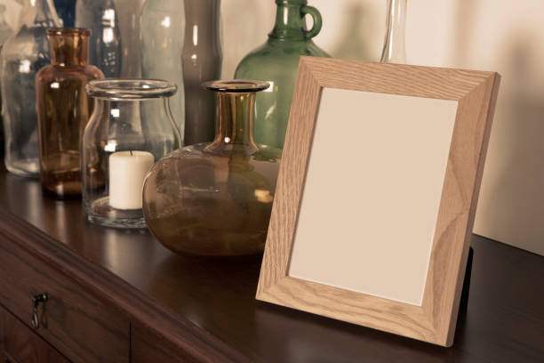 Empty Picture Frame Empty picture frame in front of a collection of vintage glass bottles table photos stock pictures, royalty-free photos & images