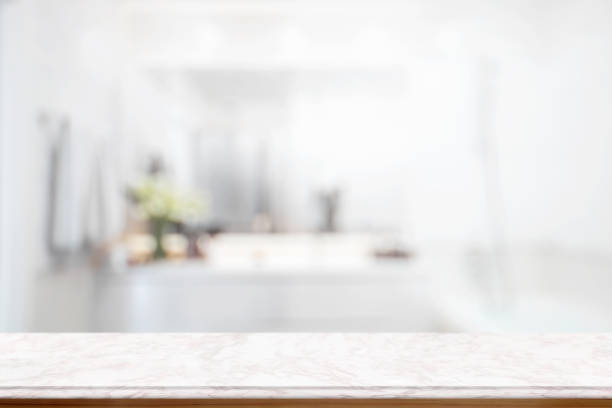 Empty pink marble top table for product display montage with blurred bathroom interior Bckground. stock photo