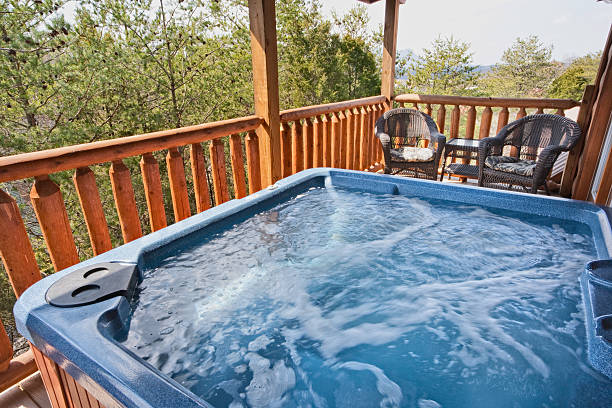 A empty running hot tub on the balcony Hot tub at a Log Cabin near the Smoky Mountains. hot tub stock pictures, royalty-free photos & images