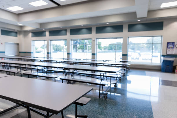Empty school cafeteria Clean, empty school cafeteria with large windows is ready for students. cafeteria stock pictures, royalty-free photos & images