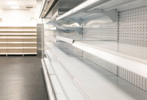 Empty shelves at a grocery store Panic buying; a series of empty shelves in a supermarket. market retail space photos stock pictures, royalty-free photos & images