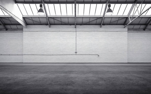 Empty storehouse interior Empty storehouse interior iluminated by spotlights and natural light from roof windows.  architectural column photos stock pictures, royalty-free photos & images