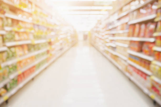 Empty Supermarket aisle shelves abstract blur defocused business background Empty Supermarket aisle shelves abstract blur defocused business background market retail space stock pictures, royalty-free photos & images