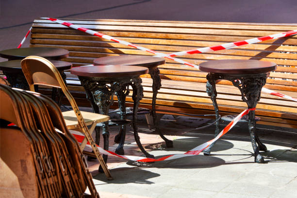 Empty terraces because of lockdown in Rotterdam Barrier tape around the empty terraces in Rotterdam during lockdown because of the coronavirus pandemic dexcom tapes stock pictures, royalty-free photos & images