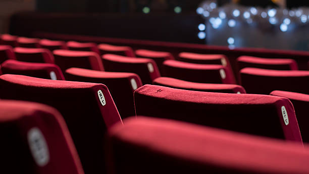 Empty Theater Chairs Empty theater with red chairs. Rear view. stage performance space stock pictures, royalty-free photos & images