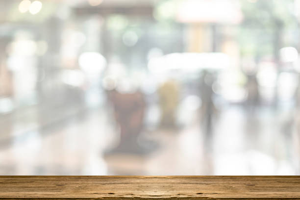 Empty top of brown wooden table with blurred of shopping mall background stock photo