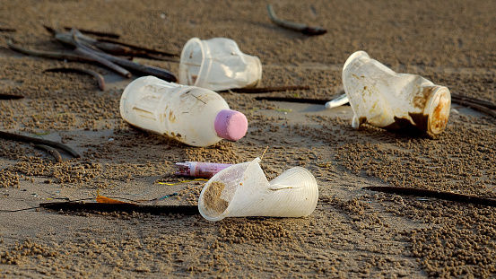 Empty Used Dirty Plastic Bottles And Cups Trash Lying On The Sea Beach ...