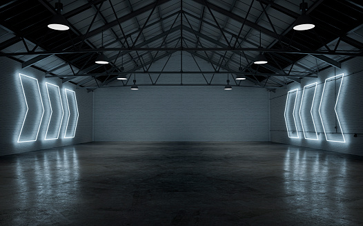 Empty large warehouse interior with cement floor, illuminated by white arrow shaped neon lights from side brick walls. A large blank brick wall background with copy space in the center. 3D rendered image.