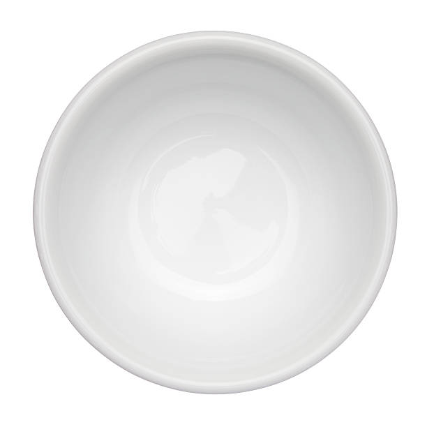 Empty, white bowl up against white background This image is isolated with light during the photo shoot process. bowl stock pictures, royalty-free photos & images