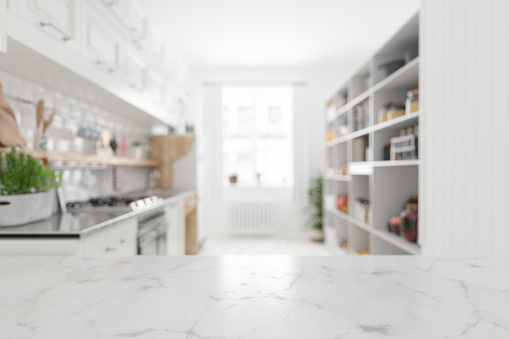 Empty White Marble Surface With Defocused Kitchen Background
