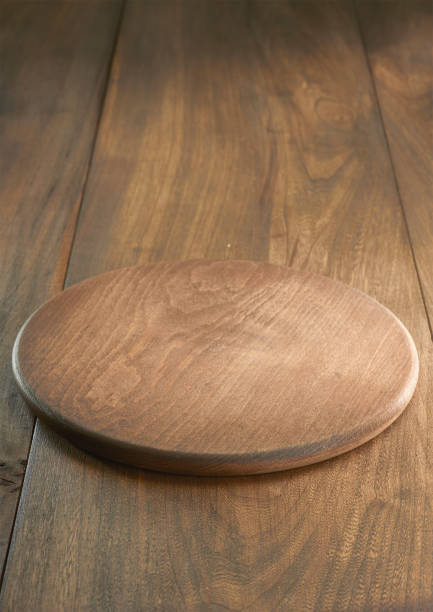 Empty wooden plate on wooden background stock photo