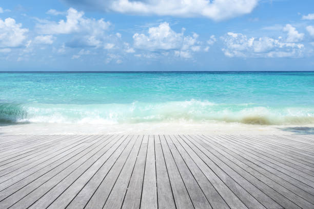 Empty wooden platform and tropical turquoise sea with blue sky background stock photo