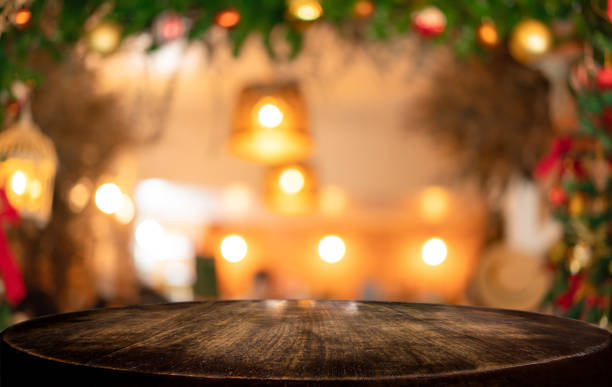 Empty wooden table and blurred Christmas background of abstract in front of coffee shop or restaurant for display of product or for montage stock photo