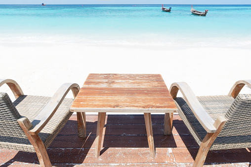 Empty wooden table and chairs on the sea view terrace