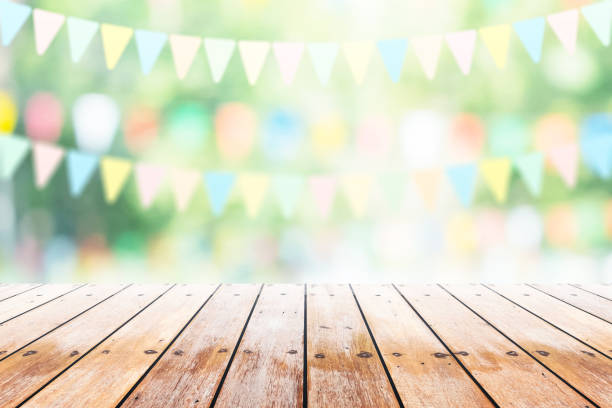 empty wooden table with party in garden background blurred. - party imagens e fotografias de stock