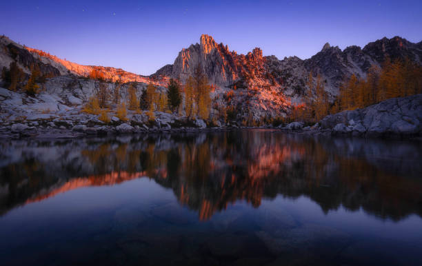 Enchanted Sunrise Sunrise with Prusik Peak reflected in Leprechaun Lake of the Enchantments, Alpine Lakes Wilderness. alpine lakes wilderness stock pictures, royalty-free photos & images