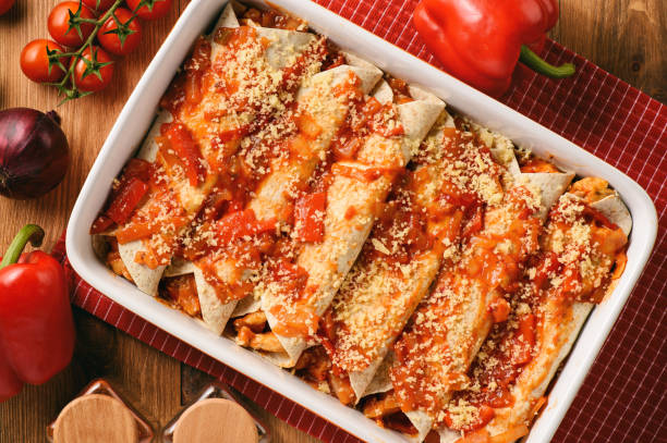 Enchiladas - mexican food, tortilla with chicken, cheese and tomatoes. stock photo