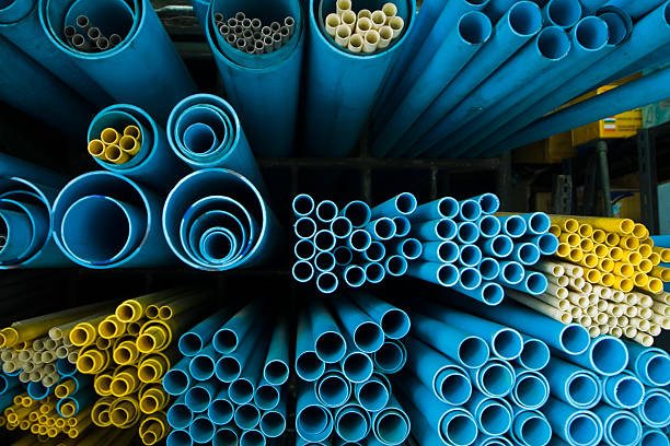 End-view of groups of different sized blue and yellow tubes stock photo