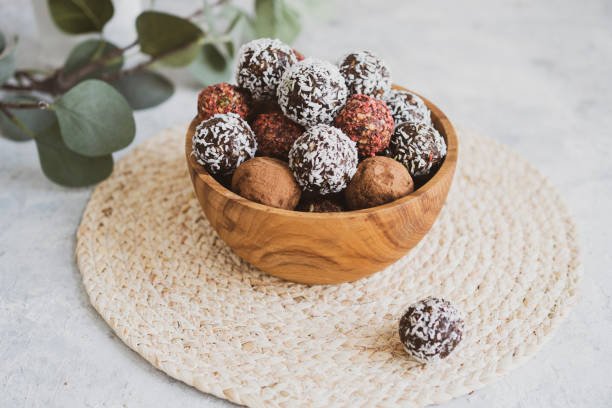 energy balls on a light table, bowl. Homemade healthy sweets stock photo