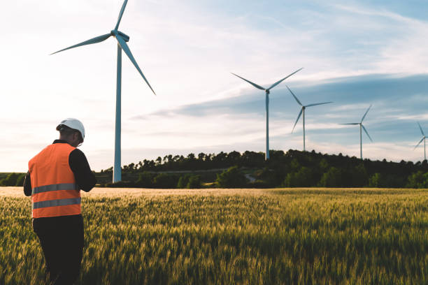 Engineer working at alternative renewable wind energy farm - Sustainable energy industry concept stock photo