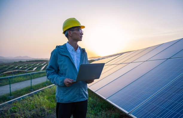 Engineer Working in Solar Power Station stock photo