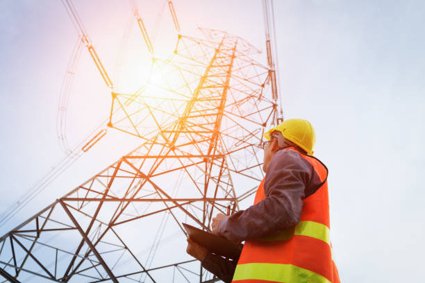 Engineering working on High-voltage tower, Engineering working on High-voltage tower,Check the information on paper. communications tower photos stock pictures, royalty-free photos & images