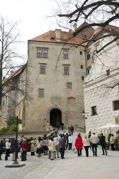 Enjoying Beauties of &#268;esky Krumlov Castle Europe "esky Krumlov, Czech Republic - April 18, 2012: Group of Japanese tourists with their guide visiting esky Krumlov Castle Complex in the small city of the same name(esky Krumlov) in the South Bohemian Region; UNESCO World Heritage Site. Small Cafe on the right." ::::: asian beauties : stock pictures, royalty-free photos & images