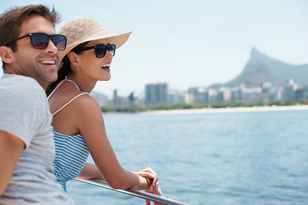 Enjoying the sights Shot of an attractive young couple enjoying a boat ride togetherhttp://195.154.178.81/DATA/i_collage/pi/shoots/783390.jpg cruise vacation stock pictures, royalty-free photos & images