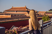 Enjoying vacation in China. Young woman in Forbidden City. Travel to China concept. Visa free transit 72 hours, 144 hours in China.