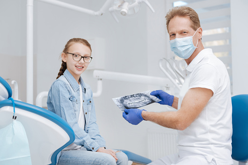 Enthusiastic Qualified Dentist Running The Diagnostics Stock Photo - Download Image Now - iStock