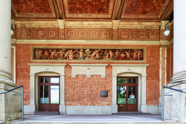 Entrance of historic pump house called 'Trinkhalle' in Baden-Baden, Germany Baden-Baden, Germany - July 2021: Entrance of historic pump house called 'Trinkhalle' lined with frescos by artist Jakob Götzenberger. The Trinkhalle in the Kurhaus spa complex in Baden-Baden was built 1839–42 by Heinrich Hübsch in a complementary architectural style as the spa's main building baden baden stock pictures, royalty-free photos & images