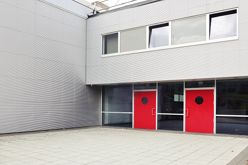 Entrance To The Modern Building Of Metal Gray Panels With Red