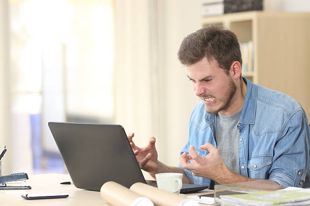 entrepreneur angry and furious with laptop - öfke stok fotoğraflar ve resimler