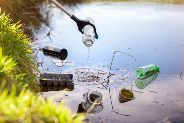 Environmental conservation collecting garbage and trash from water stock photo