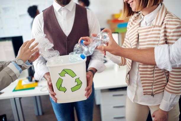 Environmentally focused employees recycling together stock photo