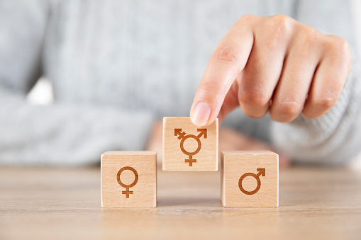 Female hand putting gender symbols
