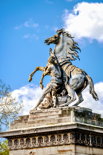 Paris, France - April 18, 2013: Equestrian statue on Place de la Concorde. The place was designed in 1755 and now is the largest public square in Paris.