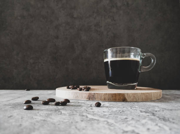 Espresso and coffee beans on grey table stock photo