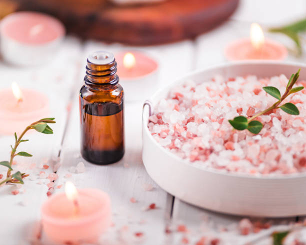 Essential oil for aromatherapy, flowers, handmade soap, himalayan salt. stock photo