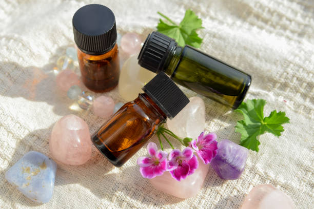 essential oils with geranium flowers stock photo