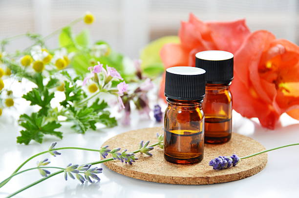 essential oils with herbal flowers stock photo