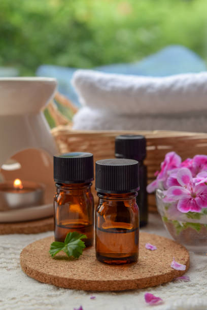 essential oils with rose geranium stock photo