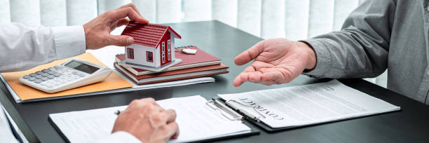 Estate agent are presenting home loan to client and discussing to decision signing agreement contract form, Home Insurance and Real estate investment concept stock photo