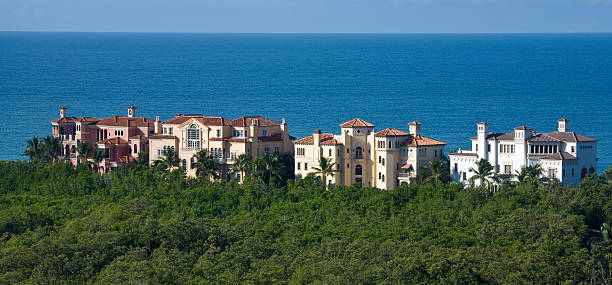 Estate Homes on the Water "A cluster of estate homes on the beach in Naples, Florida." naples florida beach stock pictures, royalty-free photos & images