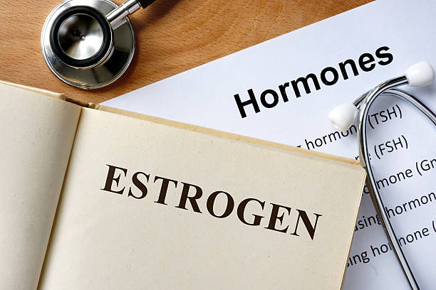 Estrogen word written on the book and hormones list.  hormone stock pictures, royalty-free photos & images