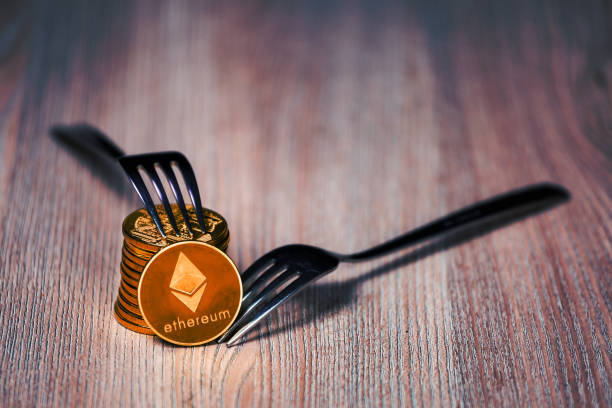Ethereum coins on a wooden table Stack of Ethereum cryptocurrency hard fork concept. Slovenia, November 17, 2018  With Ethereum  stock pictures, royalty-free photos & images
