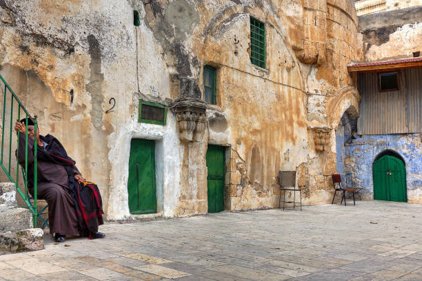 Ethiopian Monastery (Deir El-Sultan), Jerusalem Jerusalem, Israel - January 26, 2017: The old yard of the Ethiopian monastery (also known as Deir El-Sultan) located on the roof of the Church of the Holy Sepulchre in Jerusalem.  A monk in the corner keeps order in the monastery's yard. coptic stock pictures, royalty-free photos & images