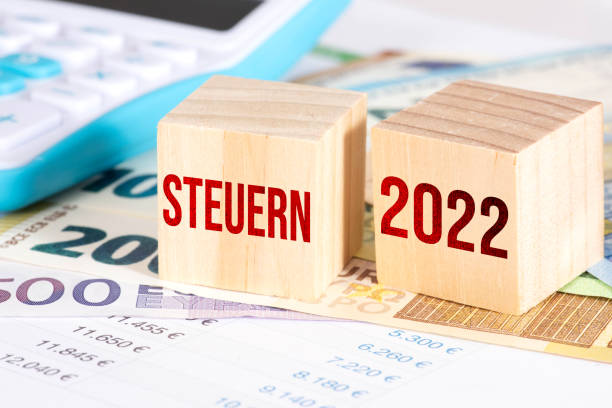 Euro banknotes, calculators and taxes in 2022 stock photo